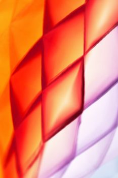 Vibrant abstract geometric pattern with warm hues of orange and purple, showcasing modern design.