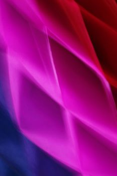 Dynamic abstract design with vibrant pink, red, and blue light patterns, creating movement and depth.