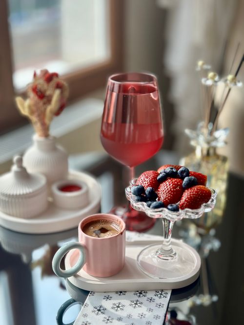 Free Luxurious breakfast setup with strawberries, blueberries, coffee, and a glass of juice. Stock Photo