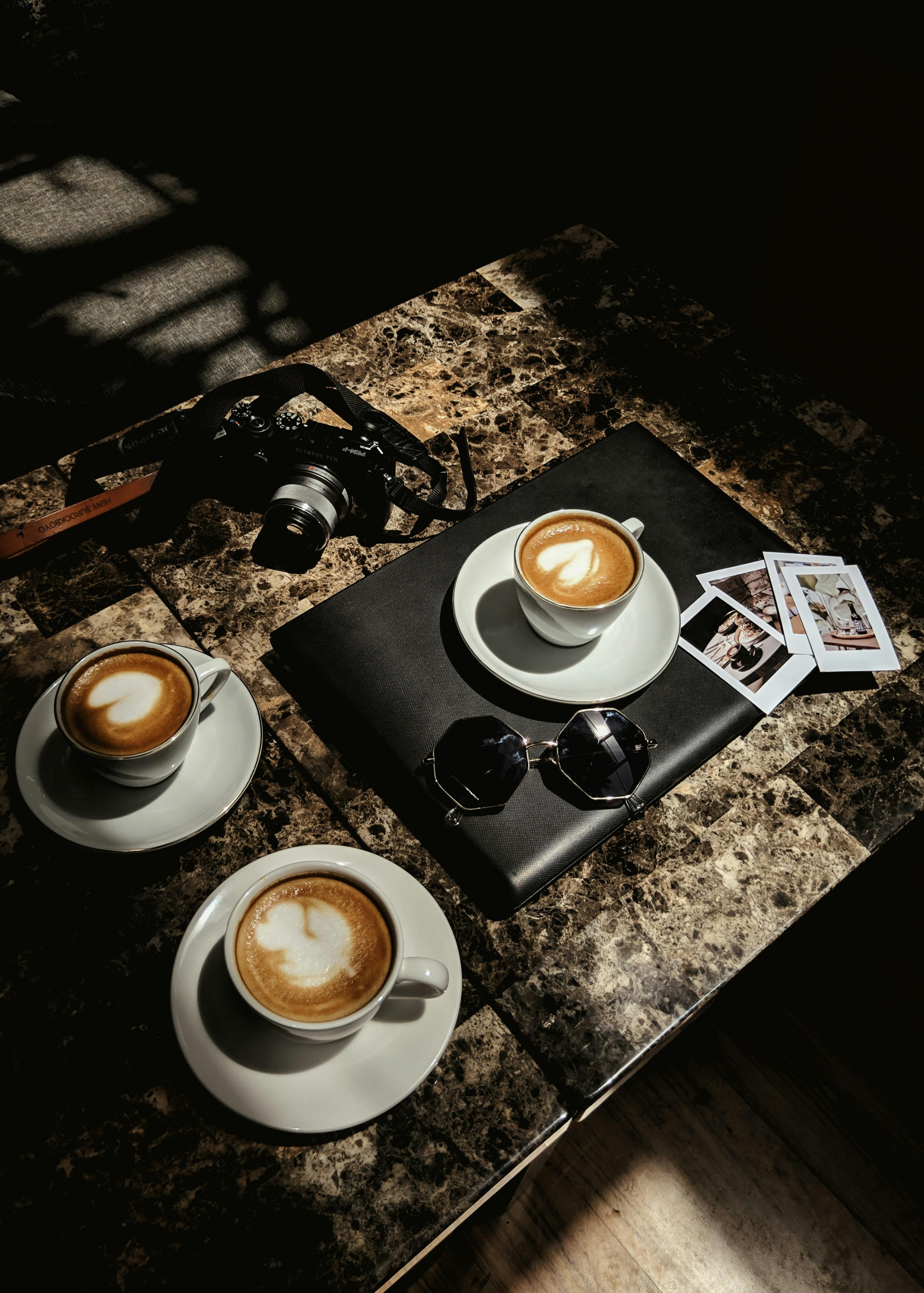 A cup of coffee next to a pair of glasses photo – Free Italy Image