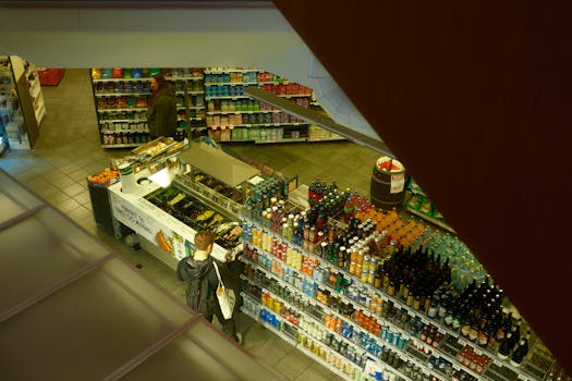 Overhead shot of a grocery store showing customers browsing the beverage aisle.
