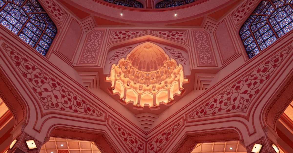 Stunning pink dome interior of Putra Mosque in Putrajaya, Malaysia showcasing Islamic architecture.