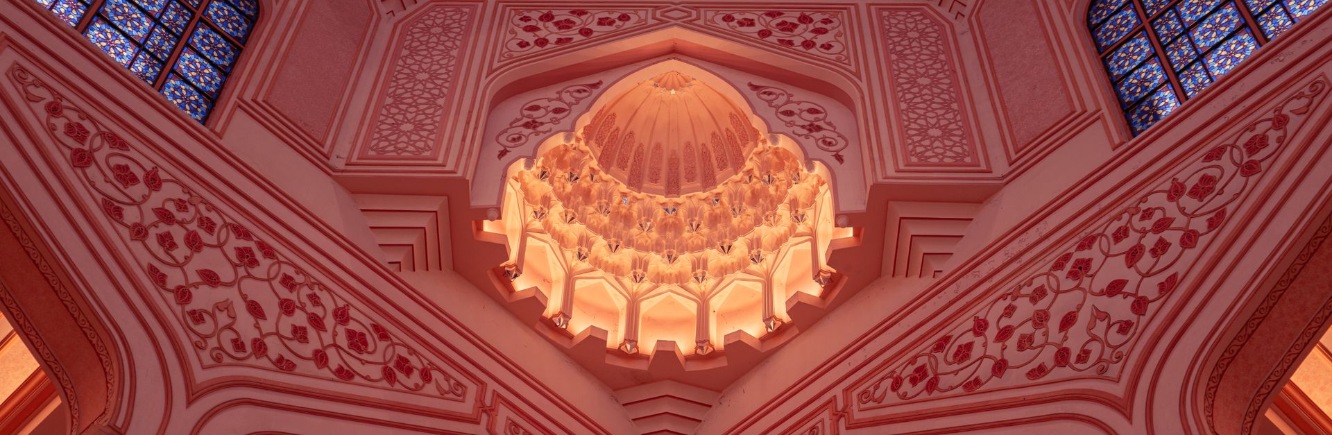 Stunning pink dome interior of Putra Mosque in Putrajaya, Malaysia showcasing Islamic architecture.