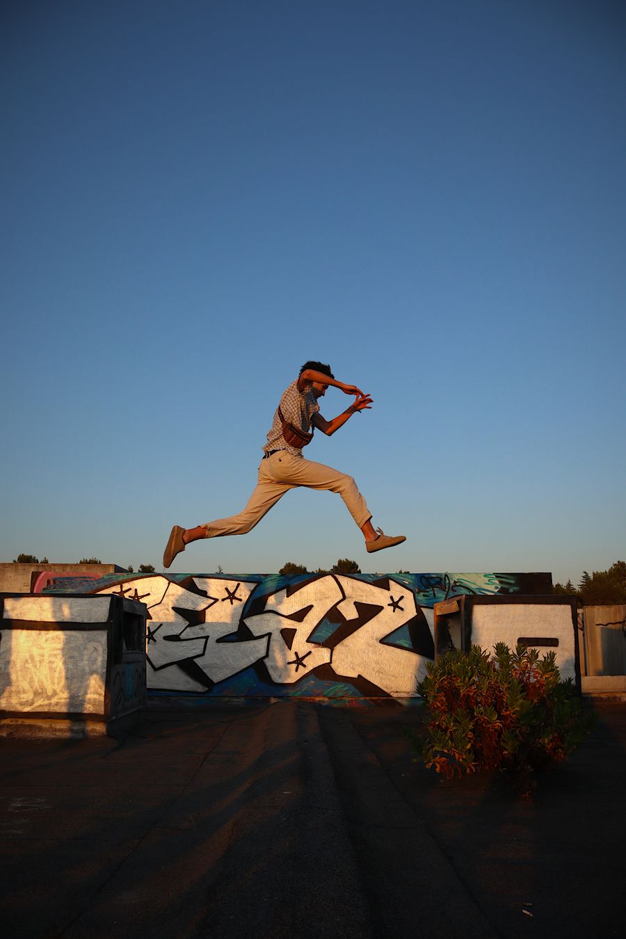 Runner leaping across a rooftop gap at sunset — photo by Botond Dobozi on Pexels