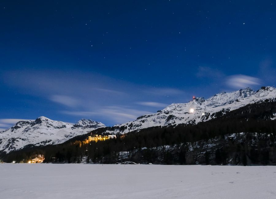 Scenic view of snowy mountains under a starry sky in Sils im Engadin/Segl, Switzerland.