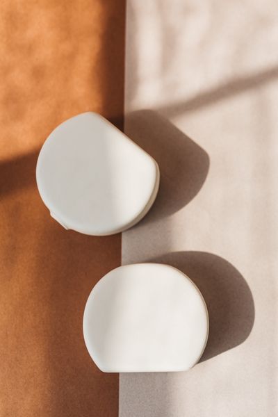Two ceramic forms on tinted paper, by Tiarra Sorte on Pexels