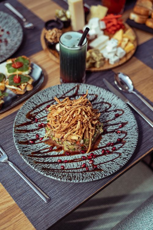 Free A delicious gourmet meal served with a variety of appetizers and a refreshing drink in Baghdad, Iraq. Stock Photo