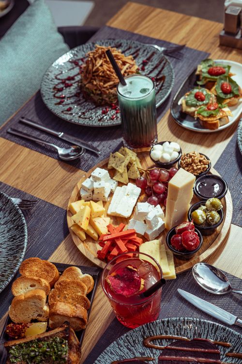 Free Delicious assortment of cheese, fruits, and nuts on a platter in Baghdad cafe. Stock Photo