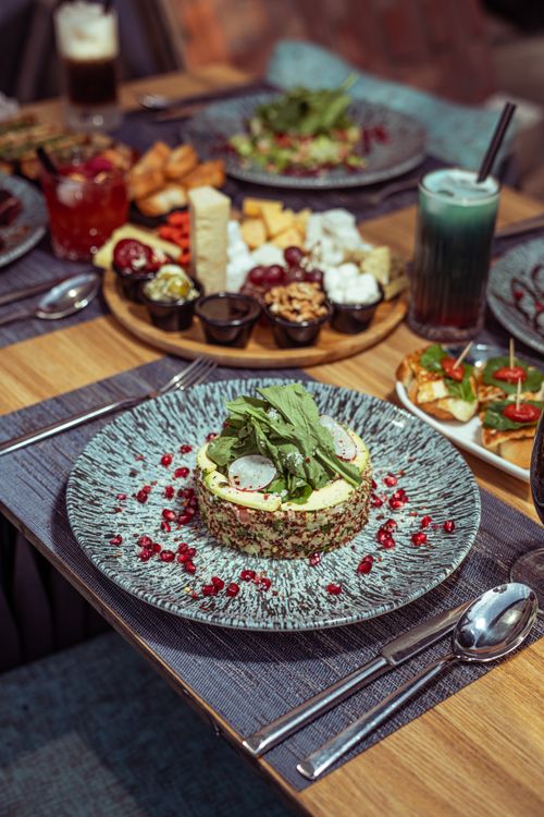 Free A spread of vibrant Middle Eastern dishes elegantly presented on a dining table. Stock Photo