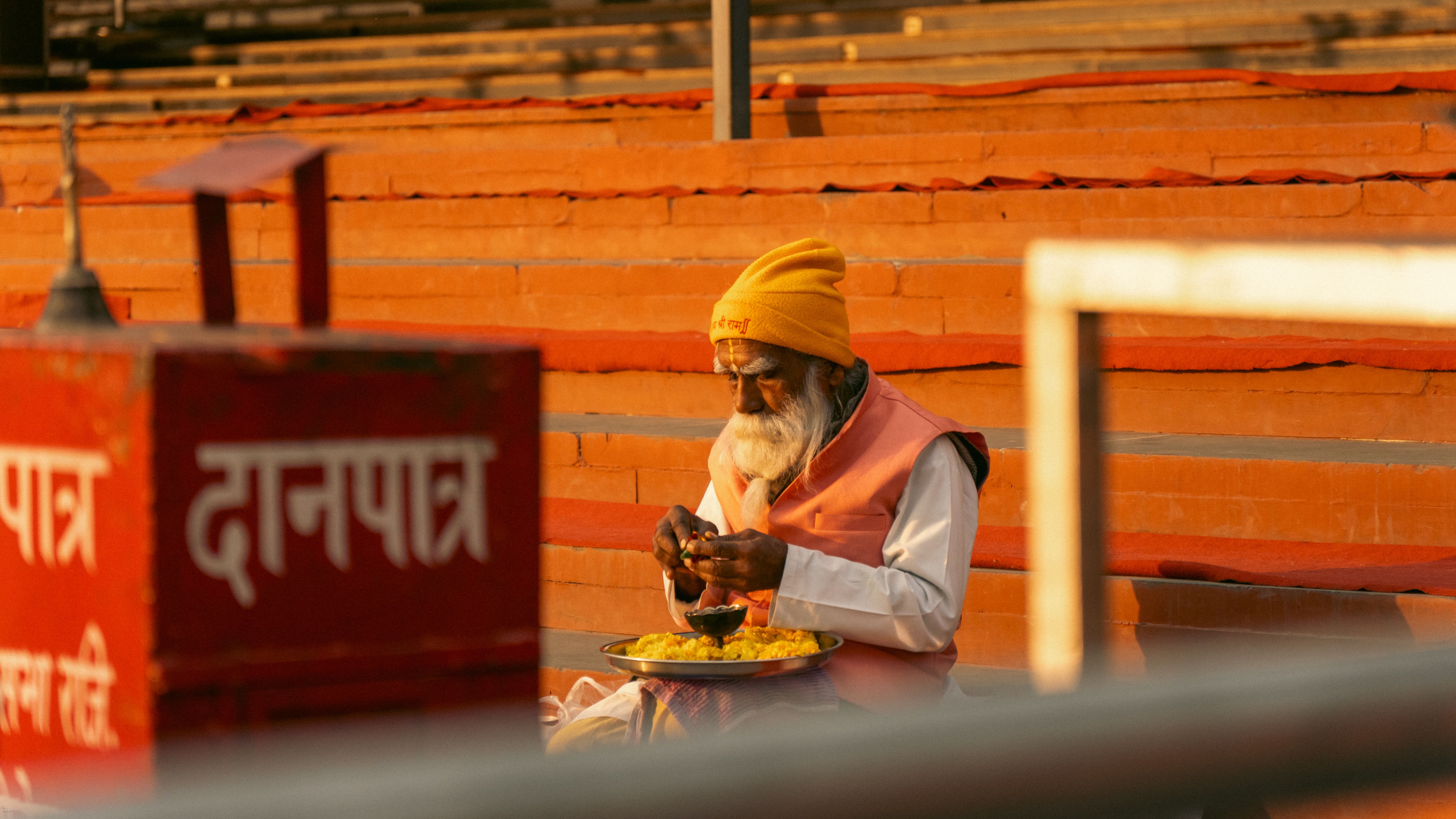 An Indian content creator typing on a laptop with Hindi script displayed on screen