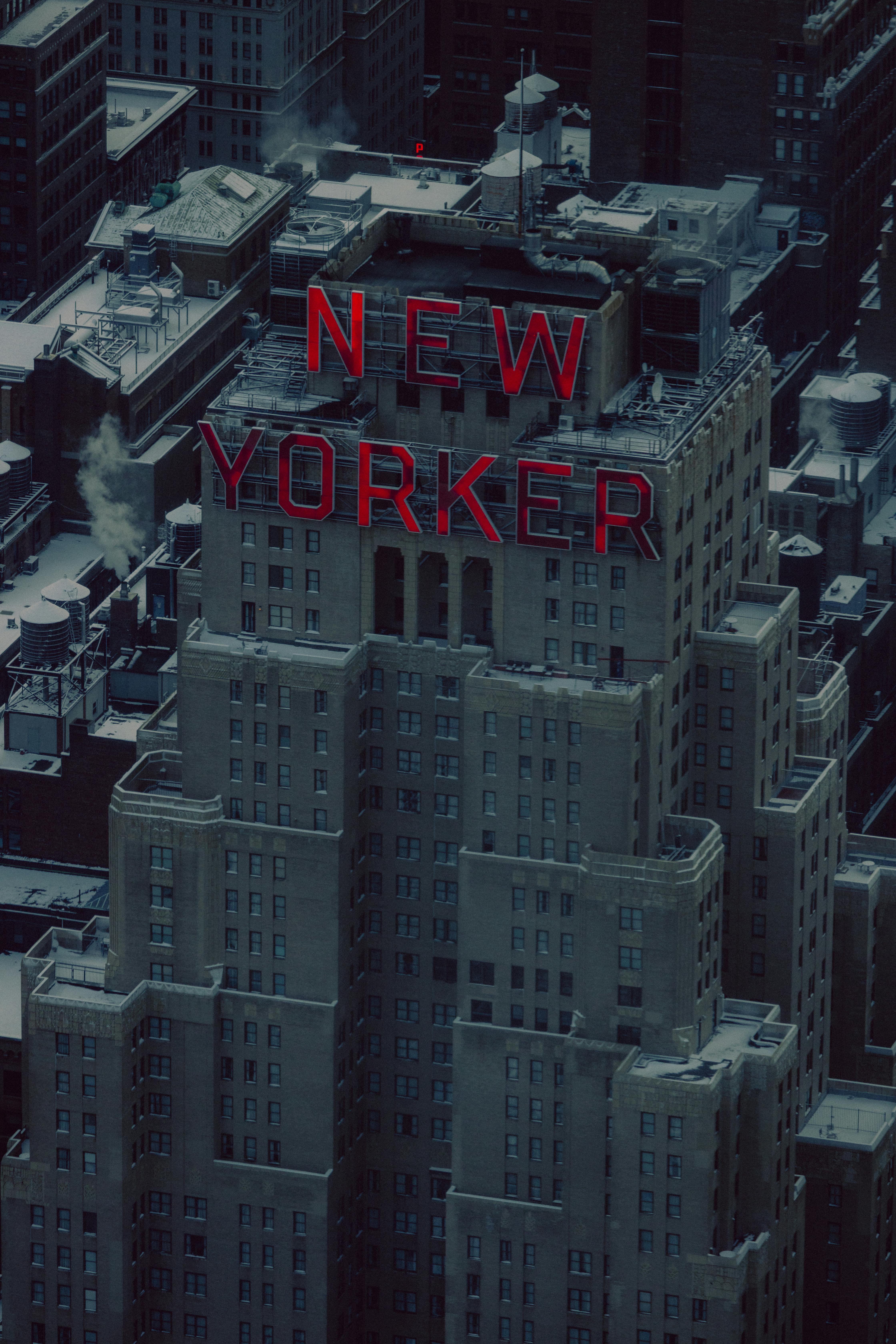 A dramatic aerial view of the New Yorker building in Manhattan at twilight.
