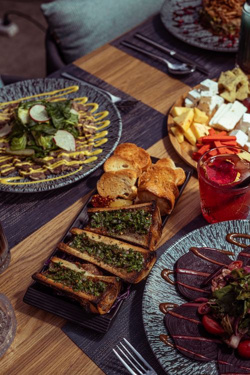 Free Savory dishes and drinks arranged elegantly on a wooden table in Baghdad, Iraq. Stock Photo