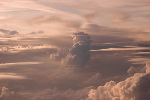 Free Breathtaking view of cumulus and cumulonimbus clouds illuminated by the warm hues of a sunset. Stock Photo