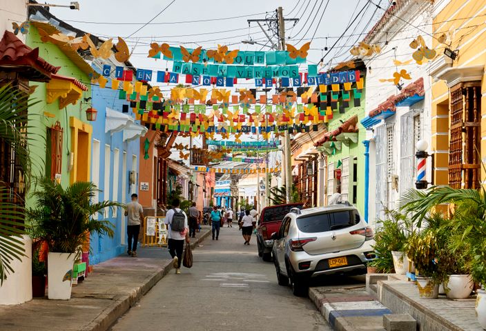 Colorful alley in Getsemani, Cartagena, Colombia, adorned with vibrant decorations and lively atmosphere.