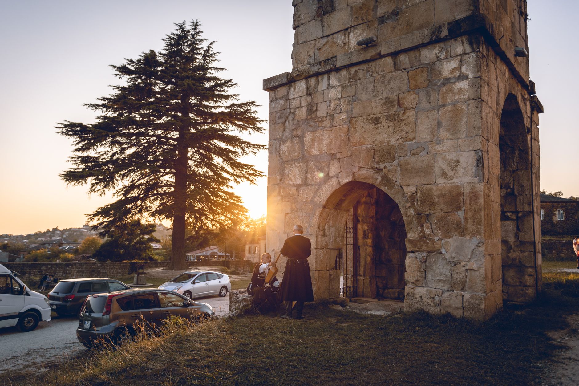 Stone structure in Kutaisi, Georgia, with sunset backdrop, showcasing historical architecture.