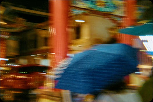 Artistic impression of a night street scene in Bangkok, showcasing movement and vibrant colors.