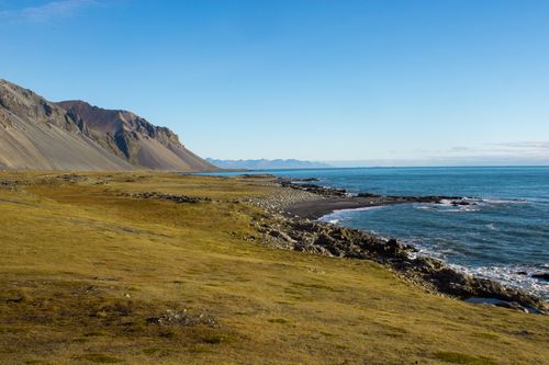 Free Discover the breathtaking coastal landscapes of Iceland with towering mountains and serene seas. Stock Photo