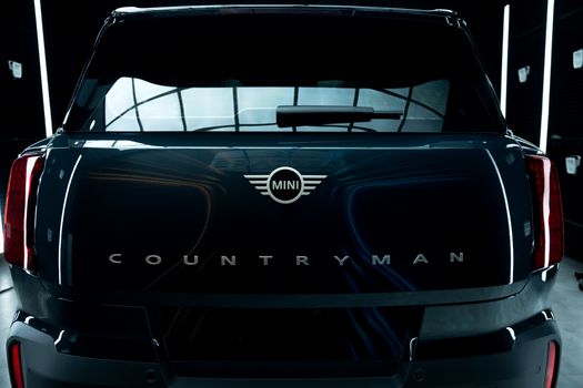 Rear view of the Mini Countryman highlighting its elegant design in a modern showroom.