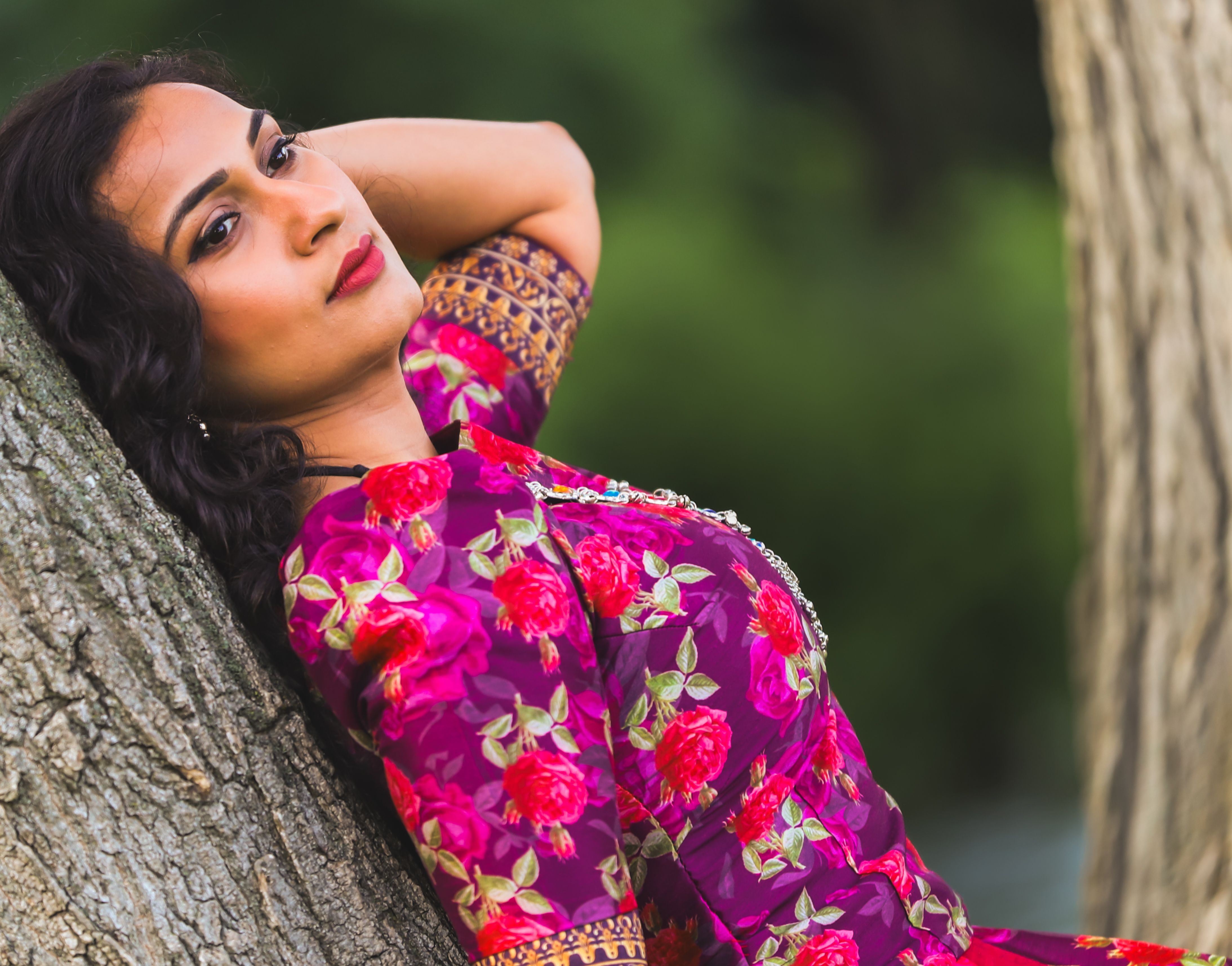 Woman in Floral Dress Relaxing Against Tree · Free Stock Photo
