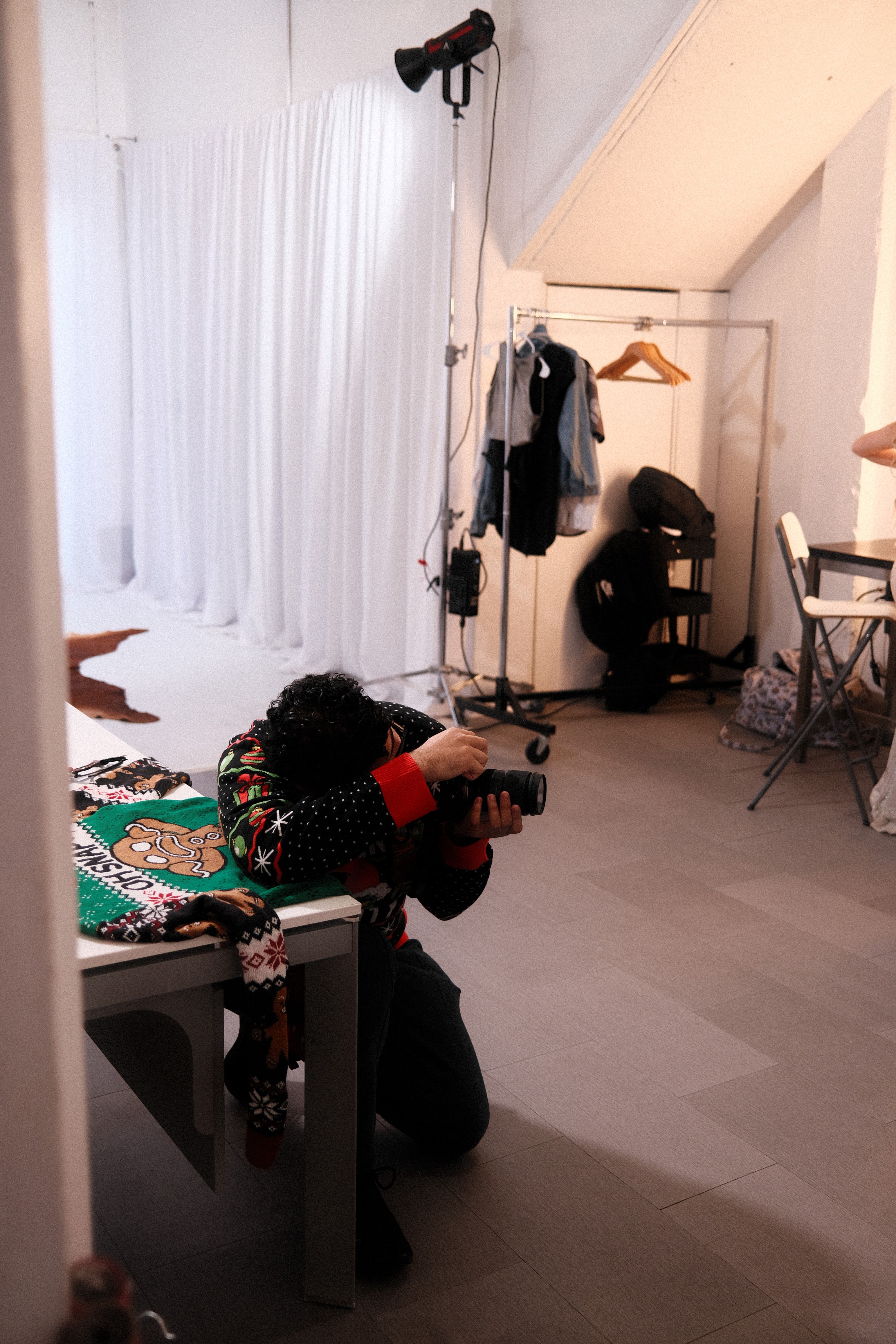 Creative photographer taking artistic shots in a modern indoor studio with stylish decor.