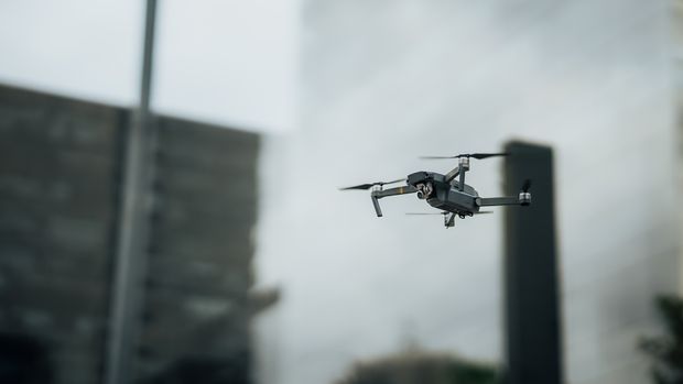 Drone flying between city skyscrapers — photo by Gustavo Denuncio on Pexels