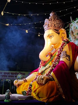Colorful Ganesh idol decorated with lights and garlands during Ganesh Chaturthi.