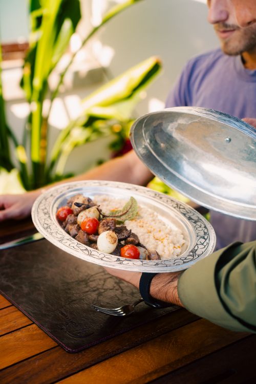 Free Delicious Turkish dish with meat and vegetables served outdoors in Side, Antalya. Stock Photo