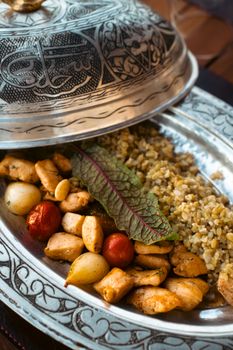 Delicious Turkish dish served with bulgur, vegetables, and grilled chicken.
