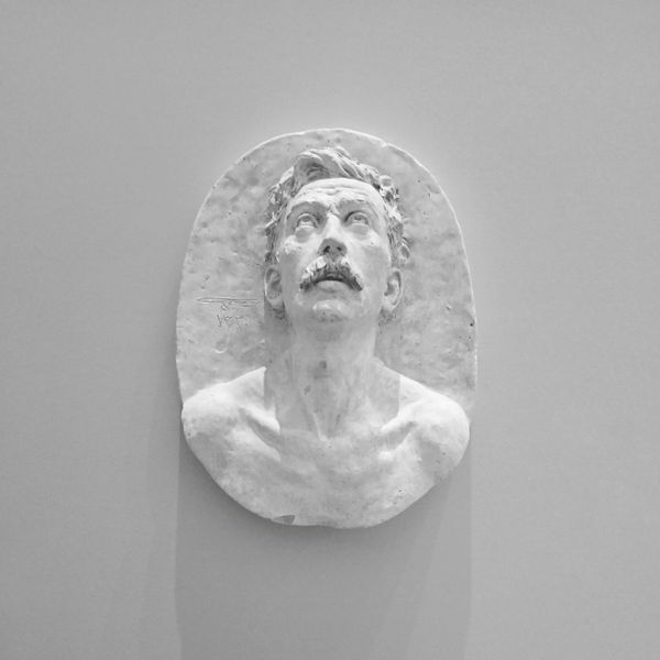 Carved marble relief of a figure looking upward. Photo by Ersan Yılmaz on Pexels