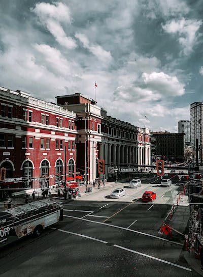 Downtown Vancouver is the city's bustling heart, encompassing vibrant neighborhoods like Yaletown, West End, and Coal Harbour. The image might showcase the sleek skyscrapers of Coal Harbour set against the backdrop of the shimmering Burrard Inlet and Stanley Park. Yaletown could be represented by its chic waterfront vibe, historic redbrick buildings, and trendy restaurants, while the West End offers a mix of modern condos and charming heritage homes nestled near lush parks and the famous English Bay beaches. Together, these areas create a dynamic urban core with a perfect balance of natural beauty, luxury living, and vibrant culture.