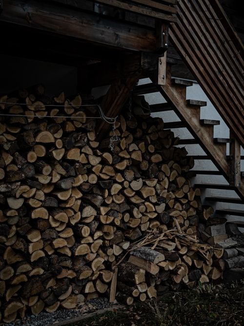 Free Stacked firewood under stairs, perfect for rustic and outdoor themes. Stock Photo