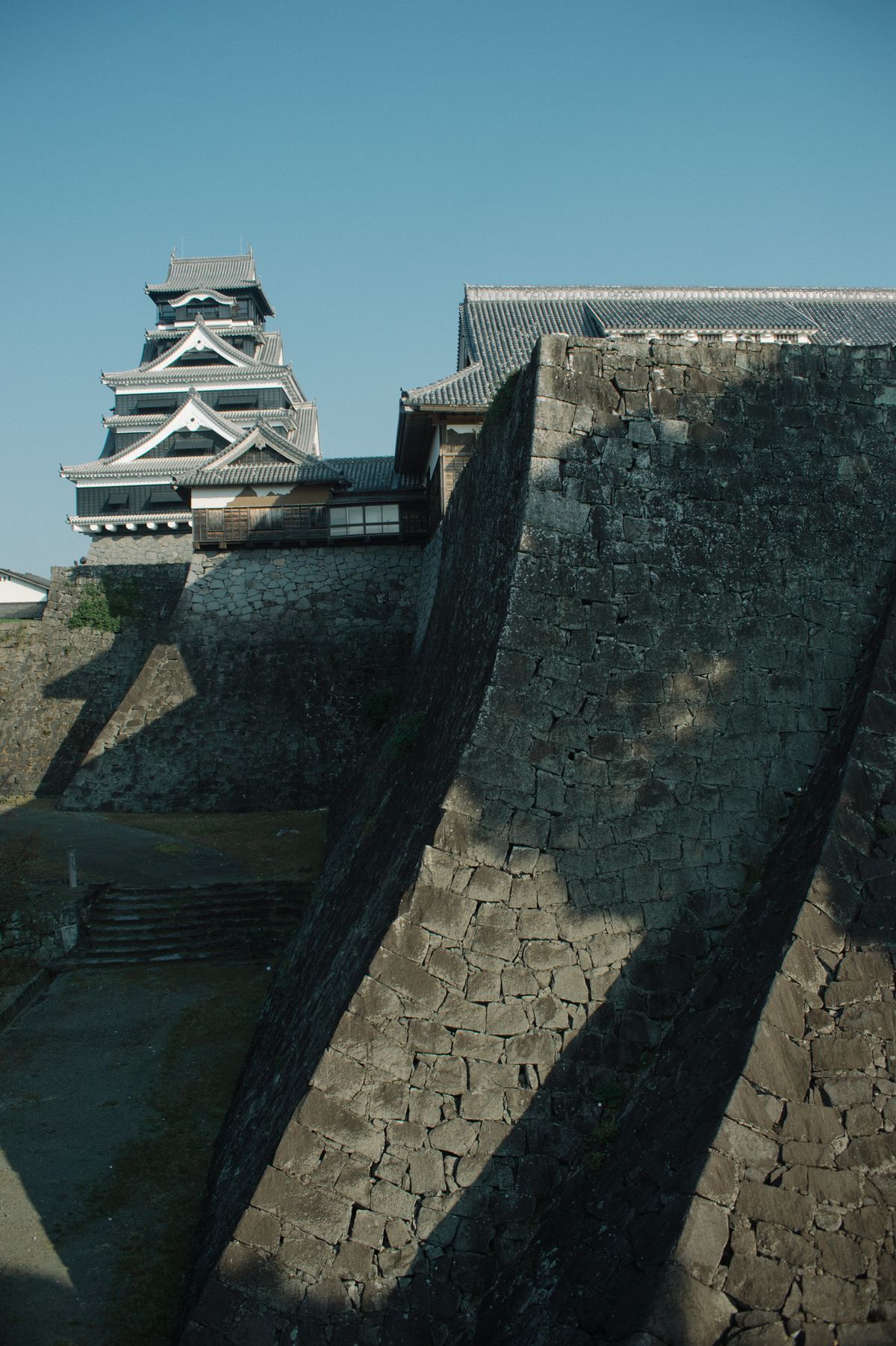 Kumamoto Castle's massive stone ramparts and black tower — undergoing 20-year restoration after the 2016 Kumamoto earthquake