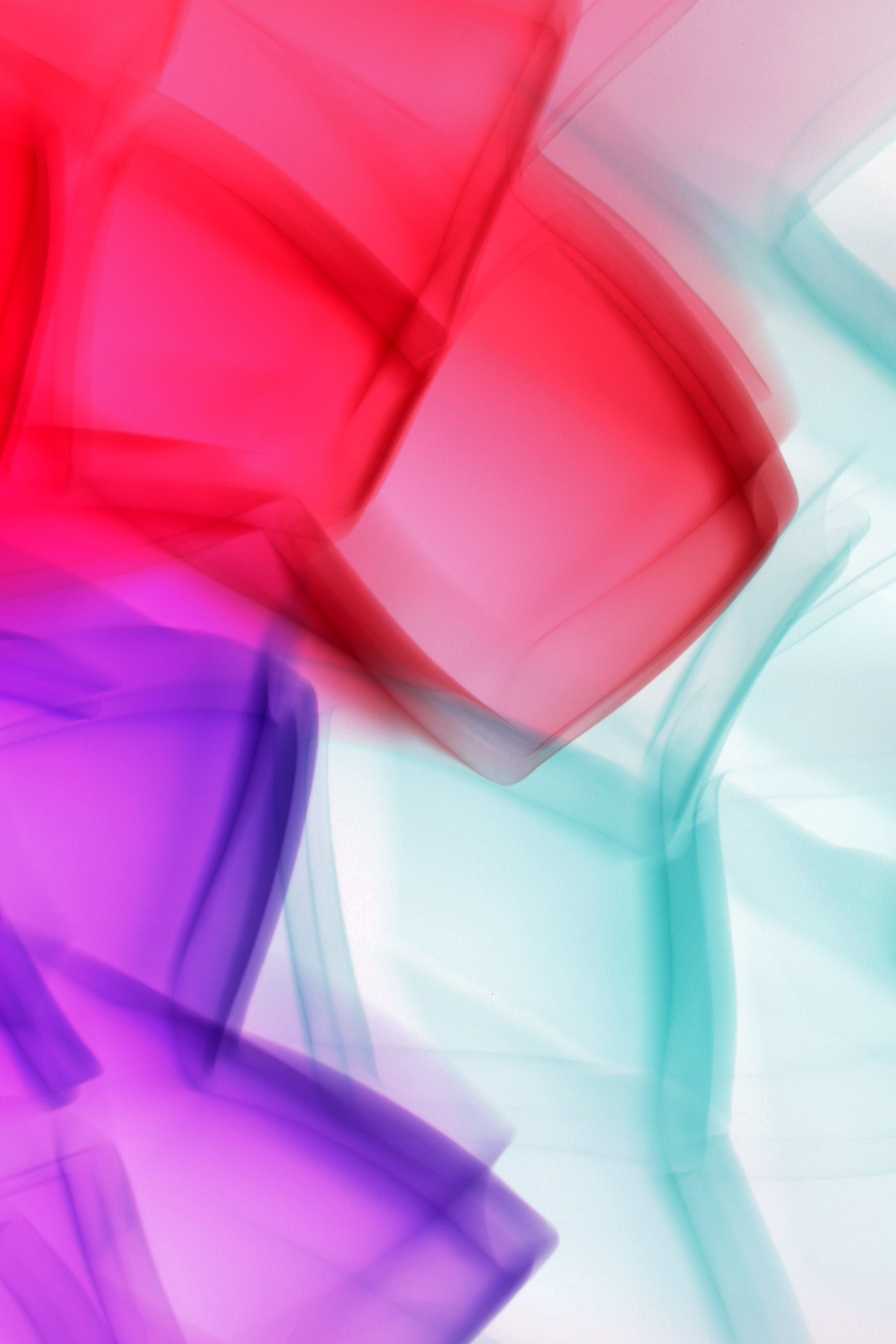 Dynamic abstract artwork featuring vibrant red, purple, and teal colors.