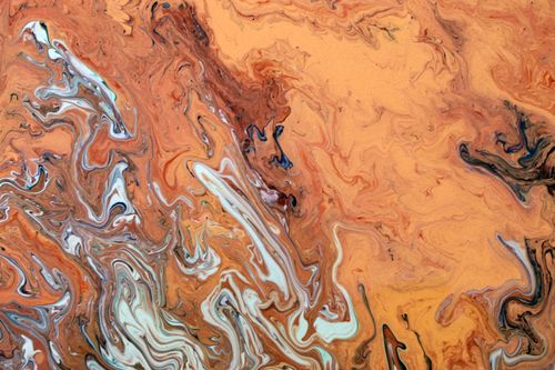 Free Dynamic abstract artwork featuring fluid swirls in earthy orange and brown tones. Stock Photo