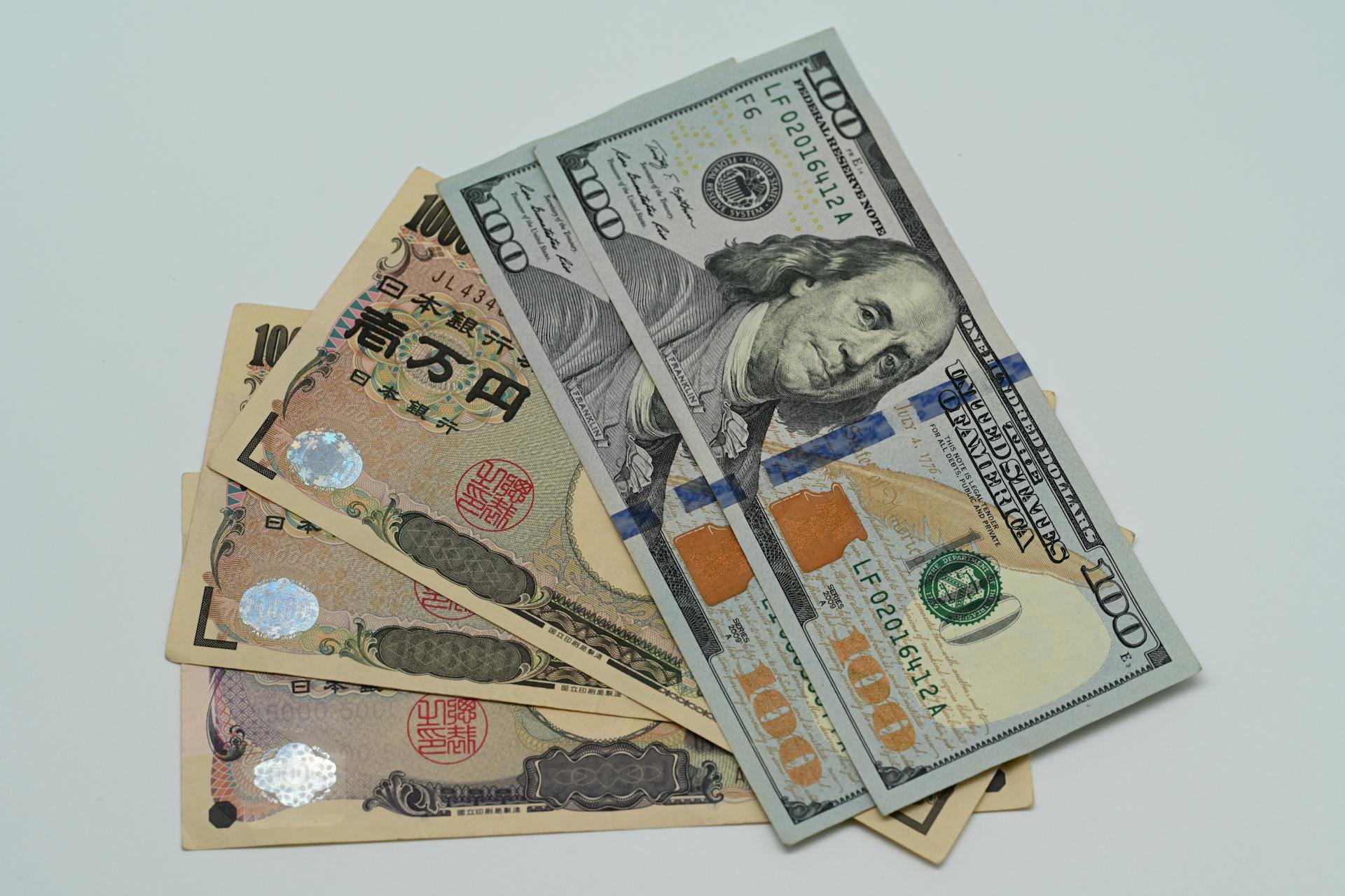 Close-up image of US dollars and Japanese yen notes, representing currency exchange concept.