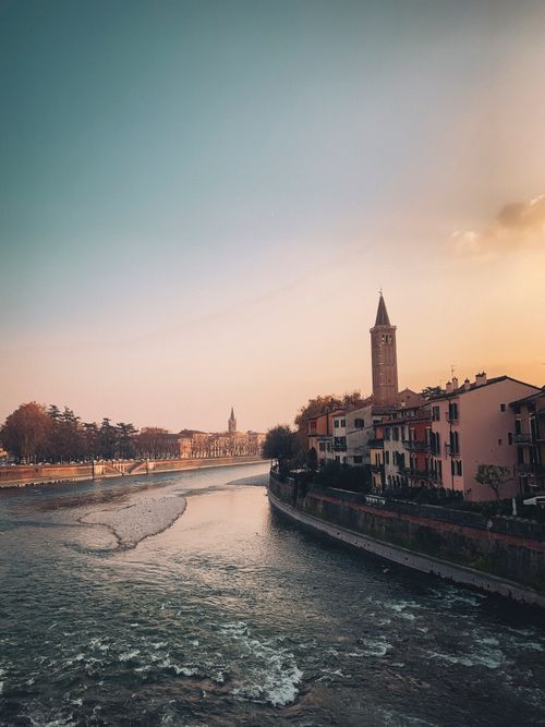 Free Beautiful sunset view of Verona, Italy, showcasing river and historic architecture. Stock Photo