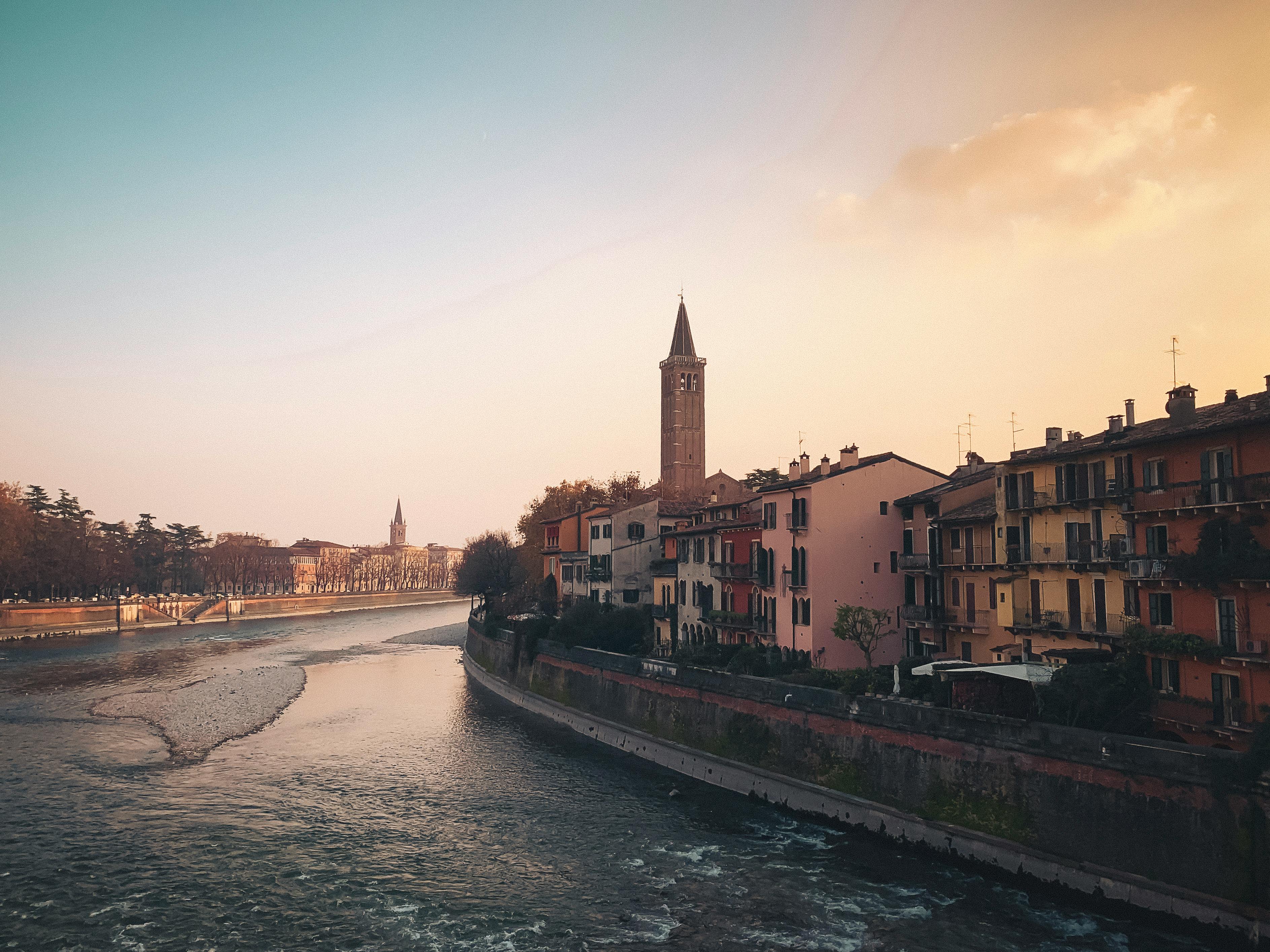 Charming sunset view over Verona, highlighting its historic architecture by the river.