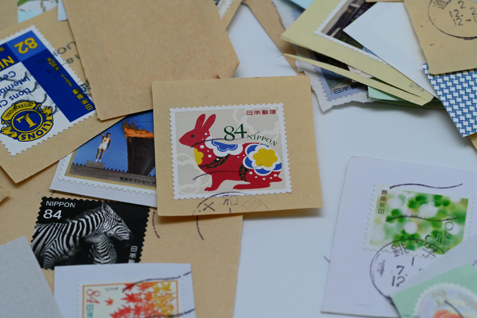 A vibrant assortment of Japanese postage stamps on envelopes showcasing cultural designs.