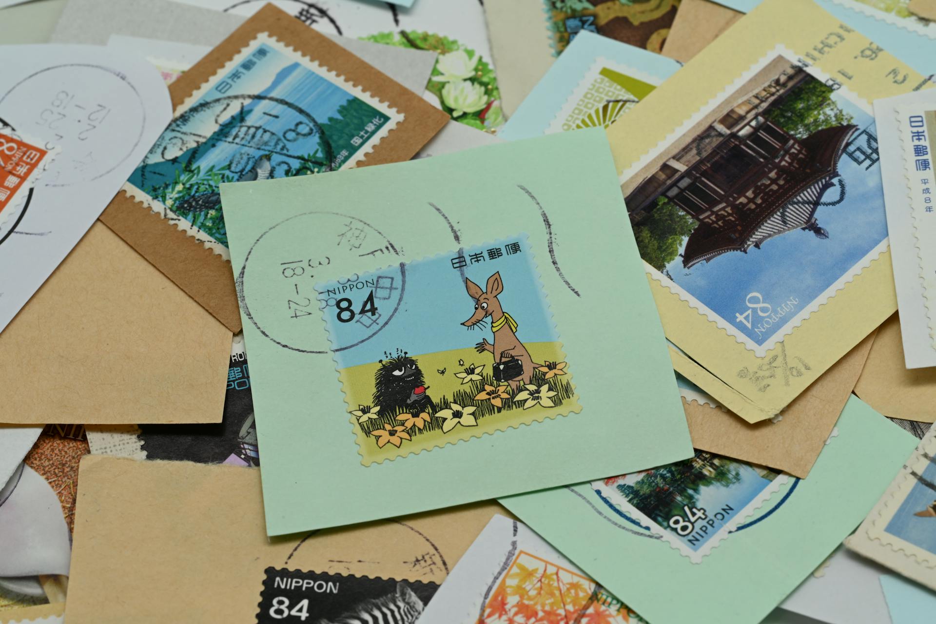 Colorful assortment of used Japanese postage stamps featuring various designs and themes.