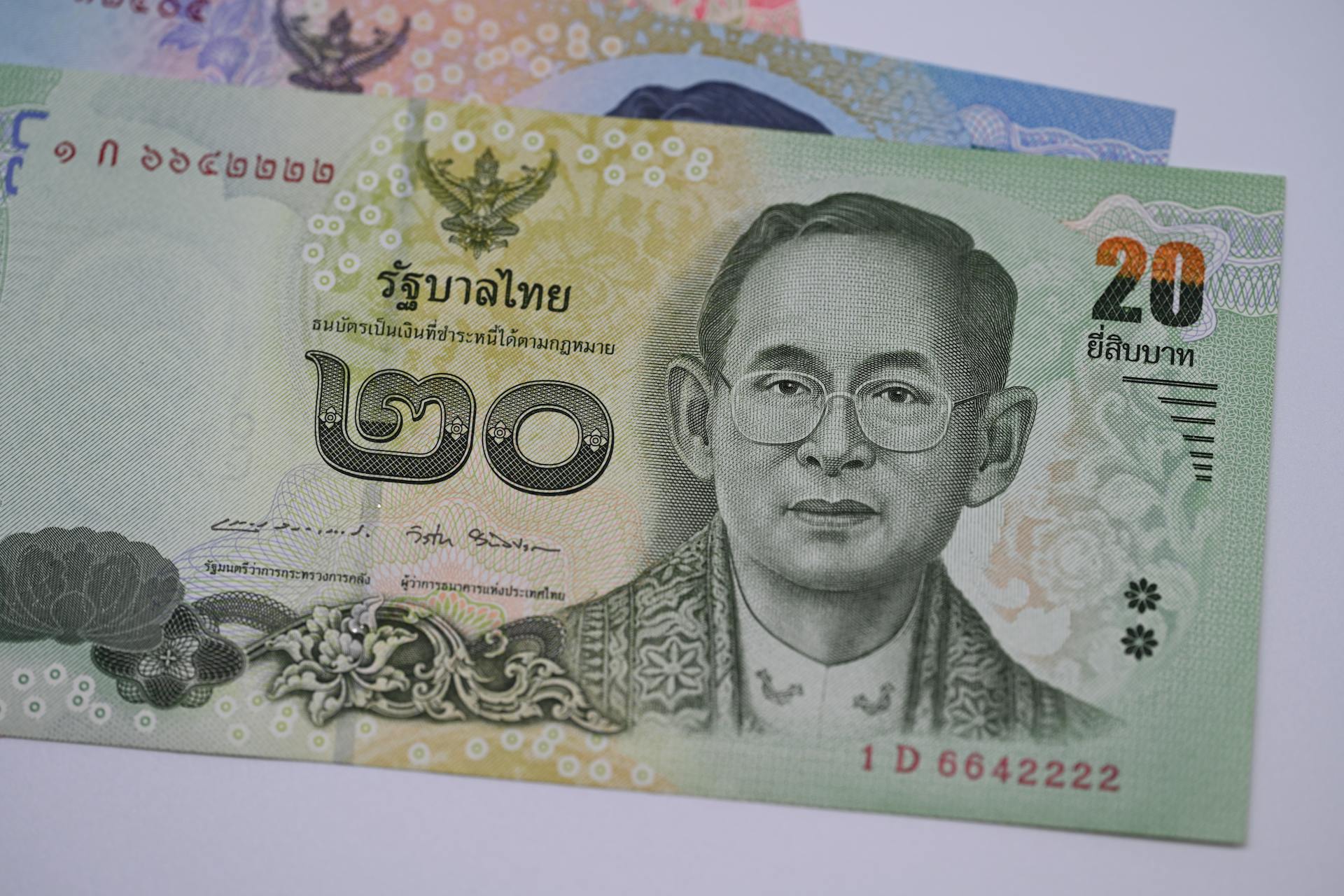 Detailed image of a 20 Thai Baht banknote highlighting traditional Thai design and currency features.