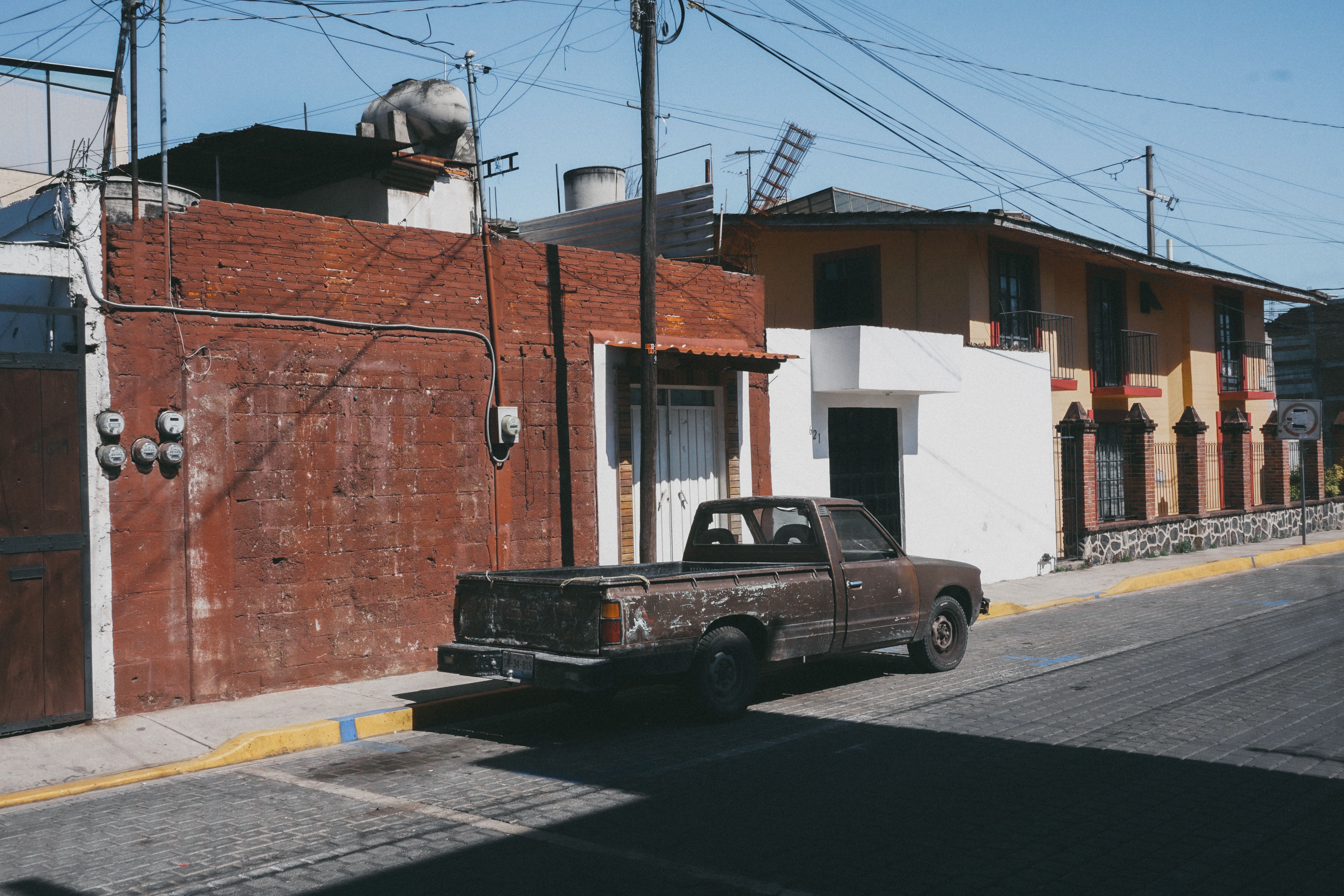 Cars and pickups parked along a highland town square during a Honduran long weekend