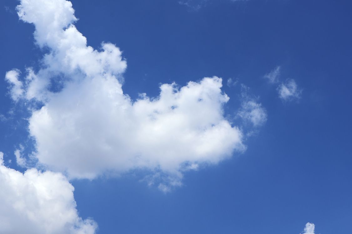 Bright Blue Sky with Fluffy White Clouds · Free Stock Photo