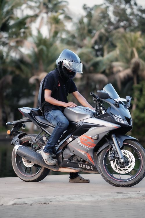 Free Person on a Yamaha motorbike outdoors with palm trees in the background. Stock Photo
