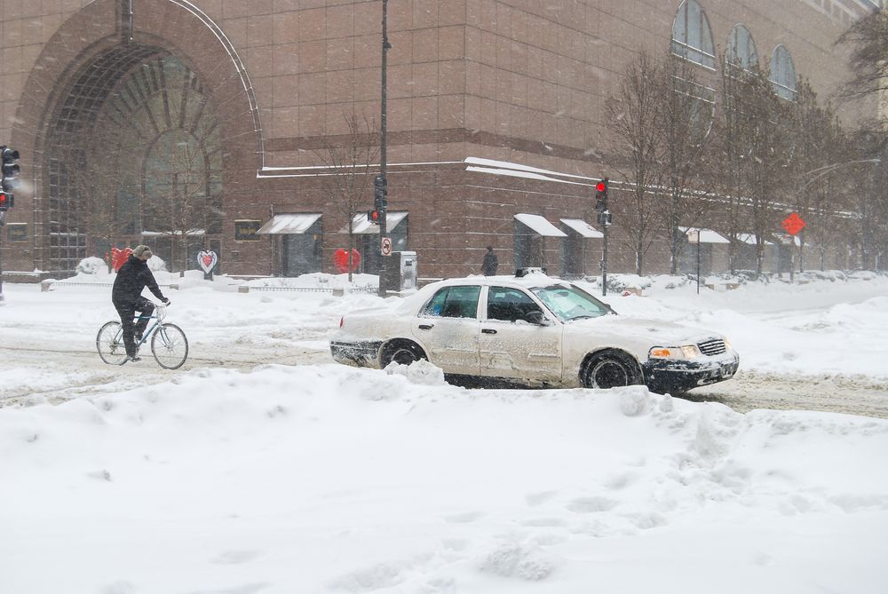 Cars moving through a snowy Chicago street