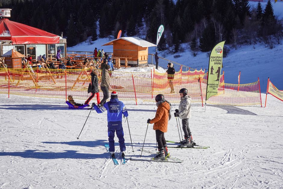 Skiers enjoy a sunny day at an Italian ski resort, capturing the essence of winter sports.