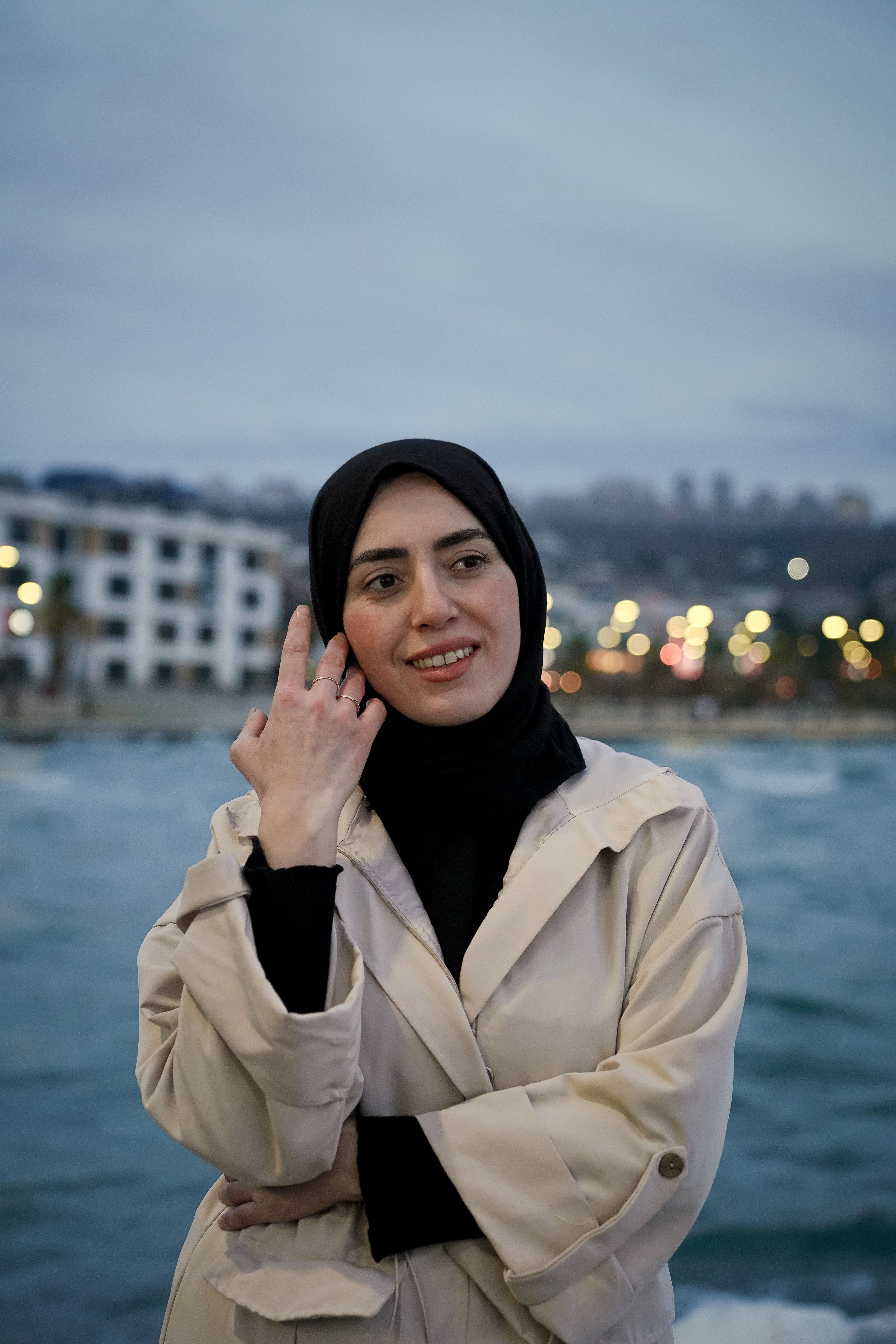 Smiling Woman by the Waterfront at Dusk · Free Stock Photo