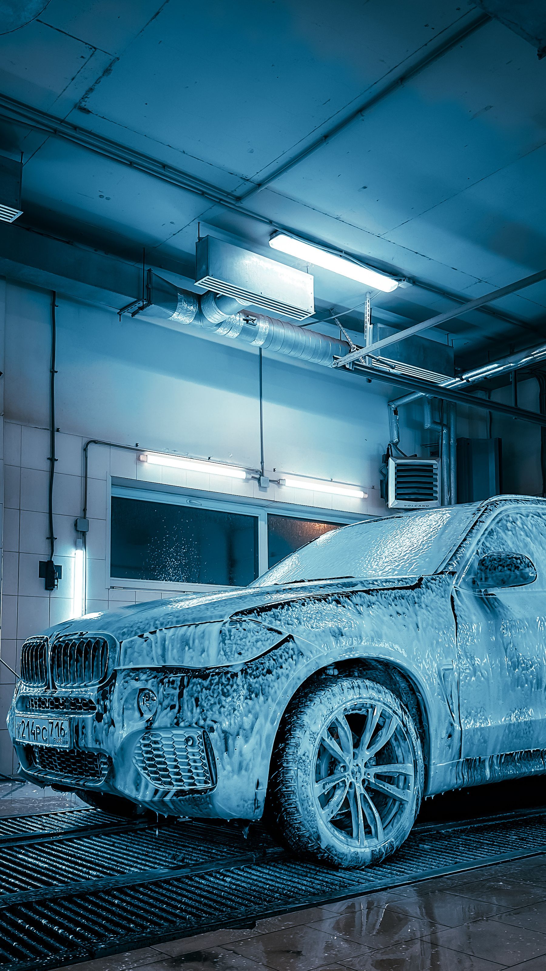 VUS premium recouvert de mousse dans une station de lavage haut de gamme.