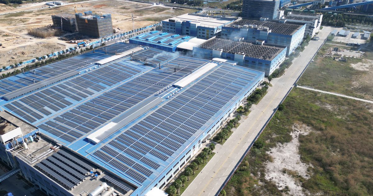 Aerial view of solar panels installed on an industrial building.