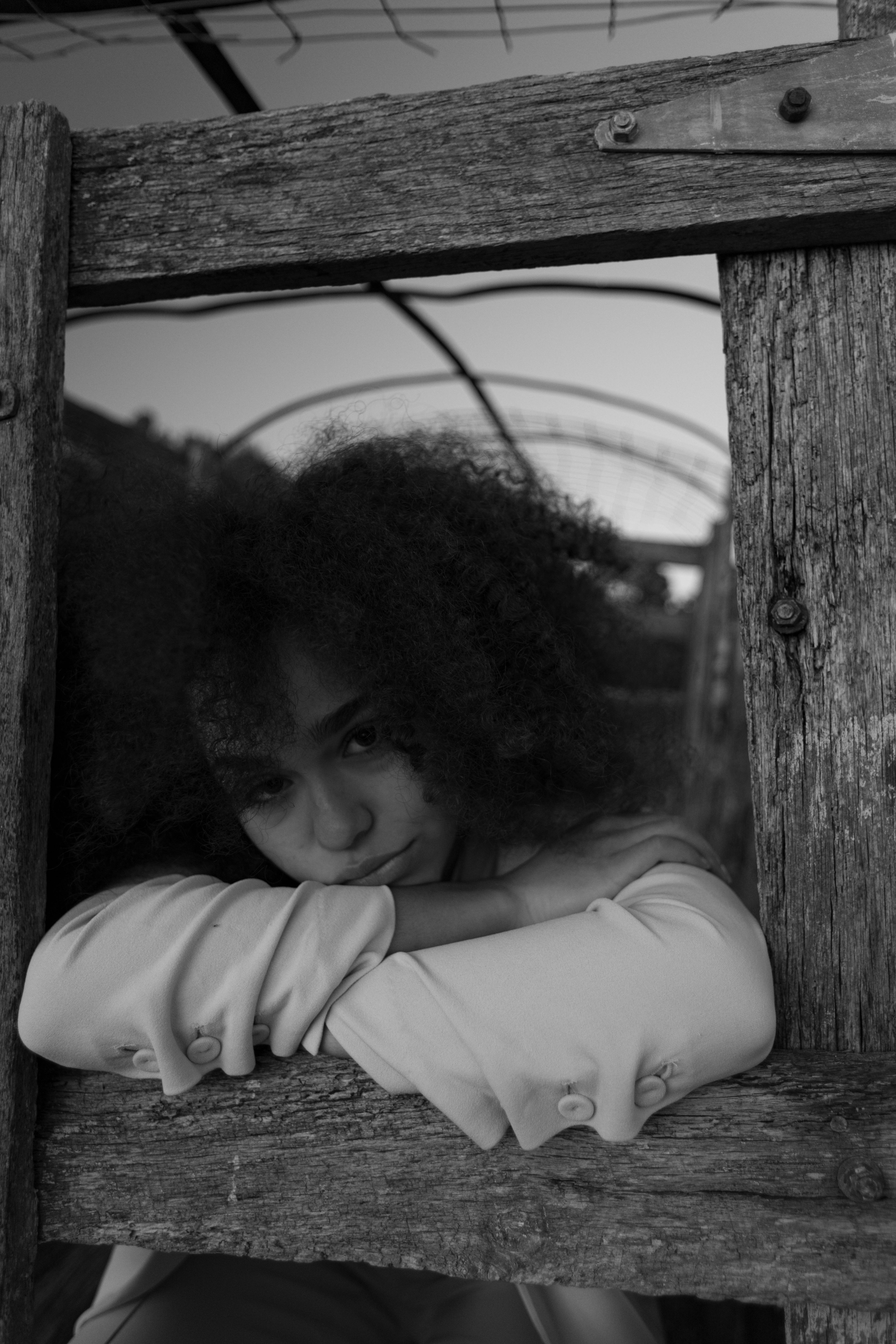 Dramatic black and white portrait of a woman in Atlanta, showcasing unique curly hairstyle.