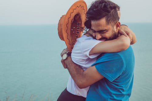 Happy couple hugging near sea